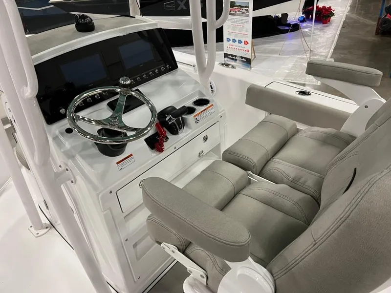 Slide: The Image of 2023 Sportsman 211 Heritage boat cockpit with steering wheel and dual seats. - 9