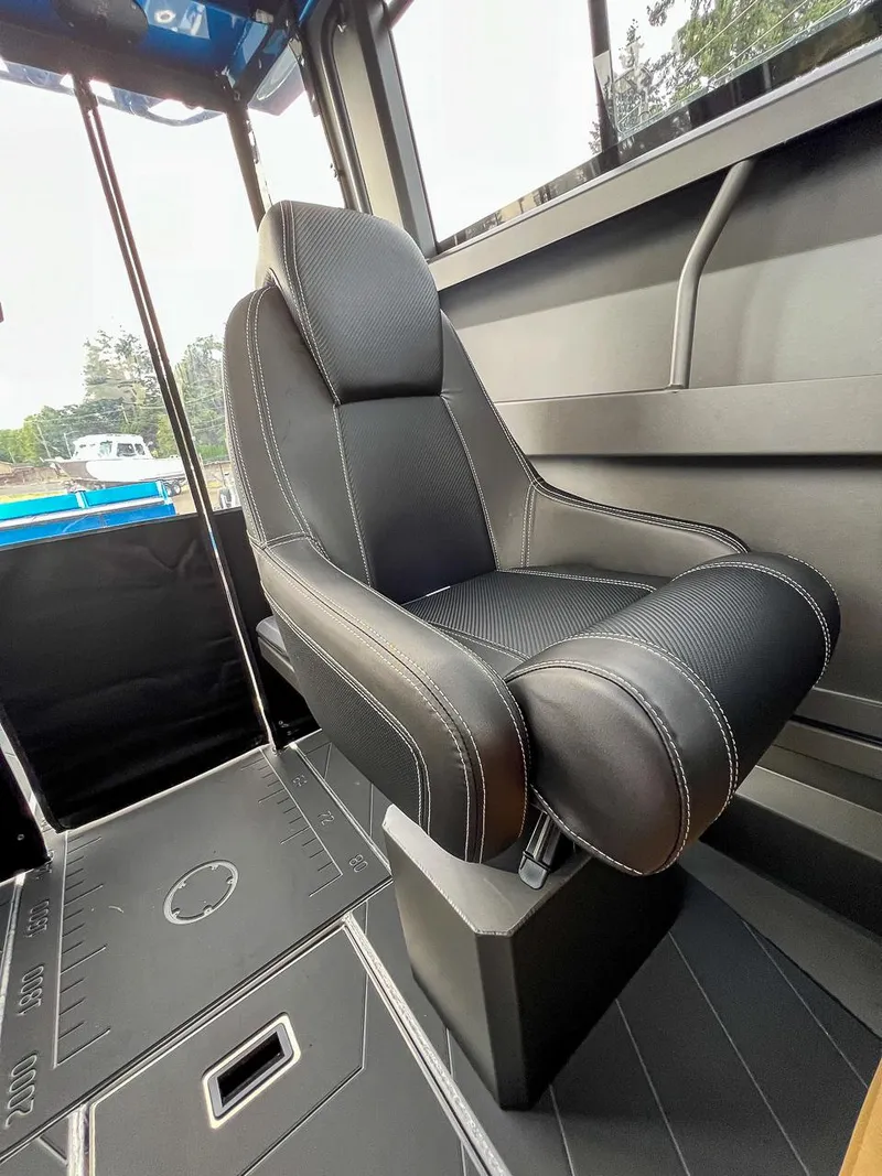 Slide: The Image of 2025 Stabicraft 2250 Ultra Centercab interior seat with black upholstery and white stitching. - 11