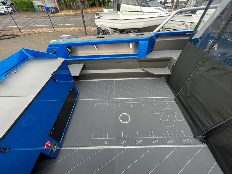 Slide: The Image of Interior of 2025 Stabicraft 2250 Ultra Centercab boat with blue and gray detailing. - 16