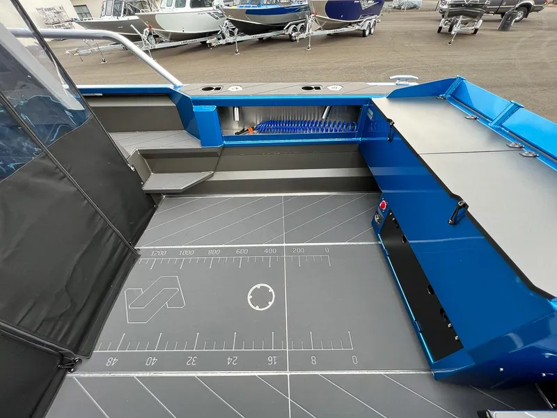 Slide: The Image of Interior view of 2025 Stabicraft 2250 Ultra Centercab boat, featuring spacious deck and storage compartments. - 17