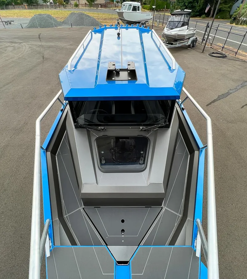 Slide: The Image of 2025 Stabicraft 2250 Ultra Centercab boat, top view, docked on pavement. - 23