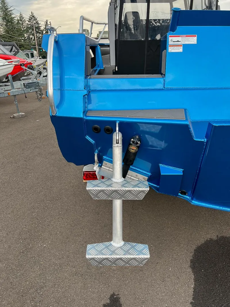 Slide: The Image of 2025 Stabicraft 2250 Ultra Centercab rear view with metal steps and blue exterior. - 24