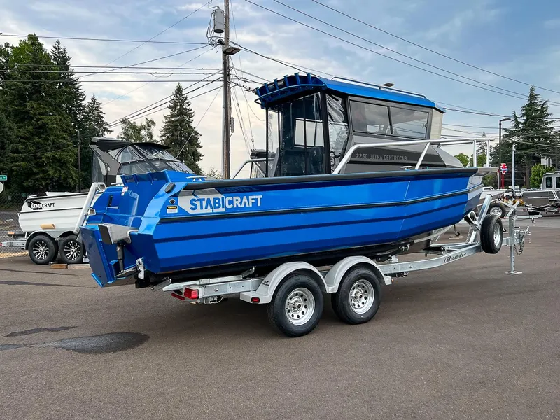 Slide: The Image of 2025 Stabicraft 2250 Ultra Centercab boat on a trailer in a parking lot. - 3