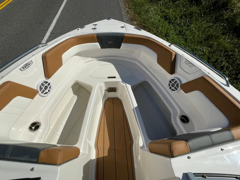 Slide: The Image of 2024 Chaparral 23 SSi OB boat interior with tan and white seating. - 13