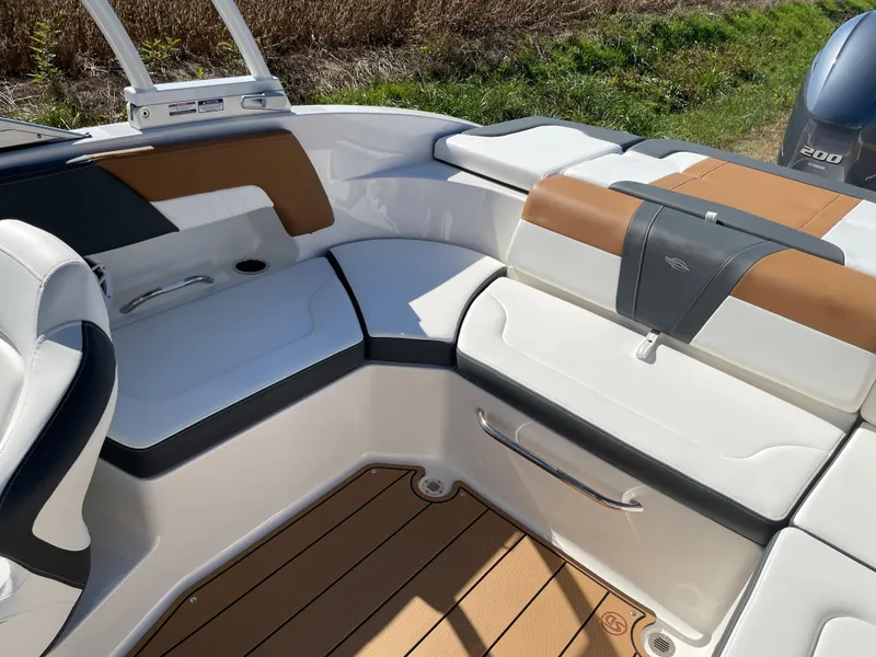 Slide: The Image of 2024 Chaparral 23 SSi OB boat interior with cushioned seating and teak flooring. - 28