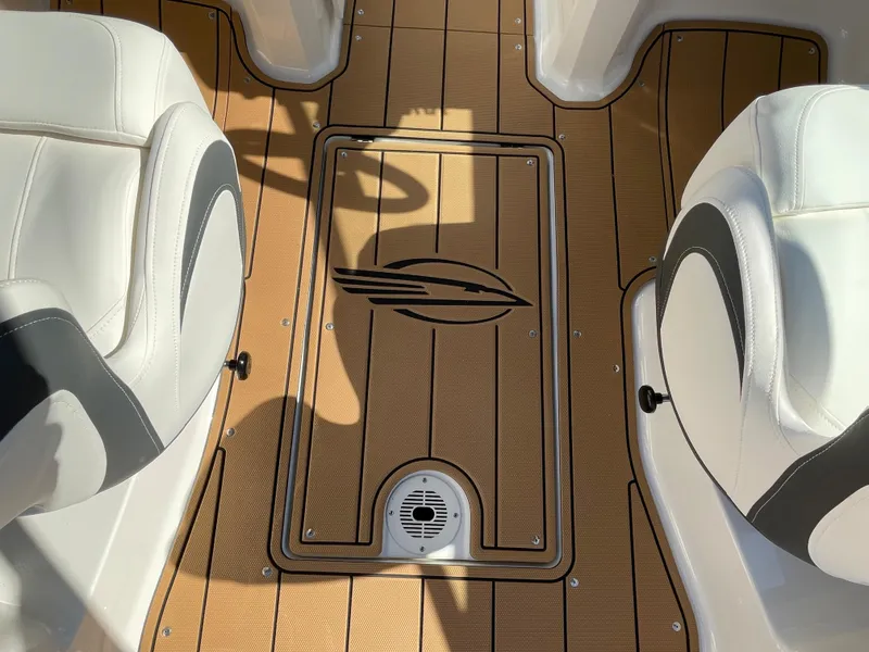 Slide: The Image of 2024 Chaparral 23 SSi OB boat interior with teak flooring and white seats. - 37