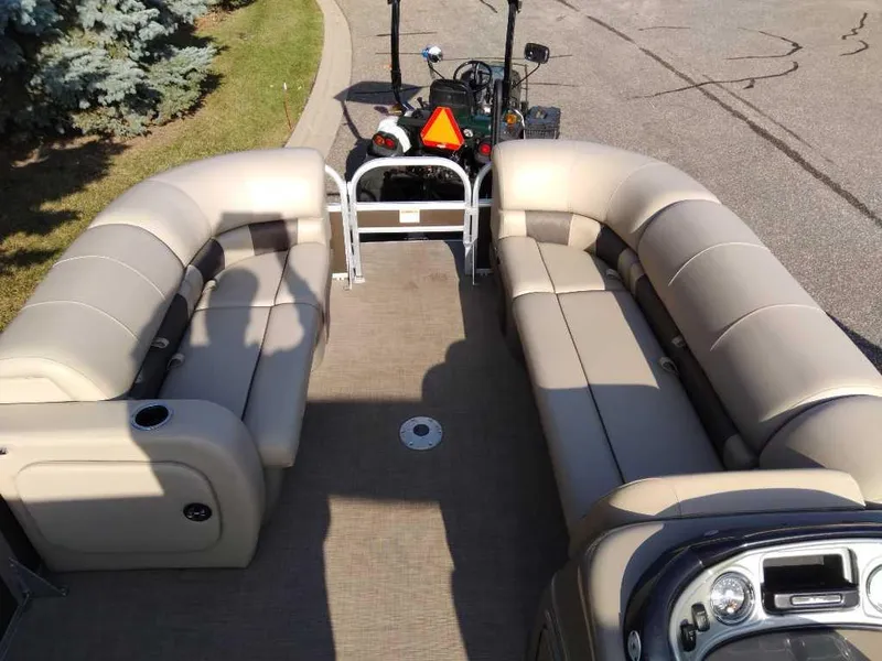 Slide: The Image of 2023 Sun Tracker SportFish 22 DLX pontoon boat with spacious seating and modern design. - 2
