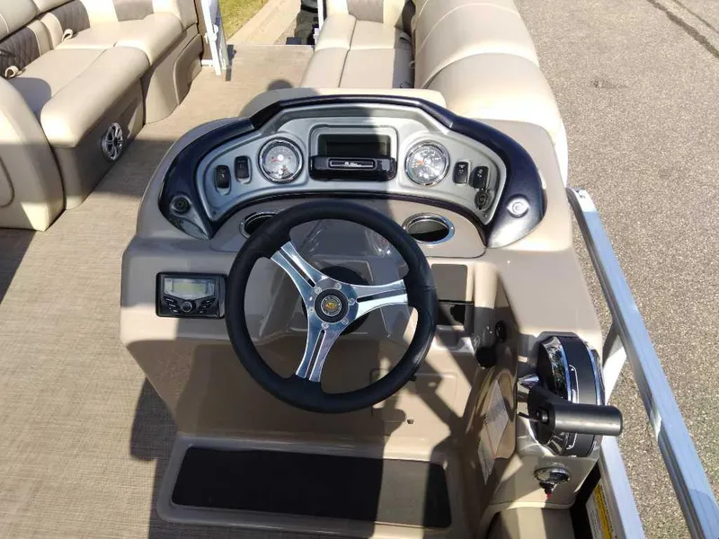 Slide: The Image of 2023 Sun Tracker SportFish 22 DLX boat dashboard with steering wheel and controls. - 4