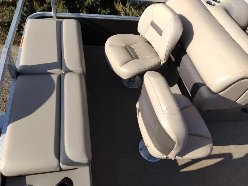 Slide: The Image of 2023 Sun Tracker SportFish 22 DLX boat interior with beige seating and spacious layout. - 6