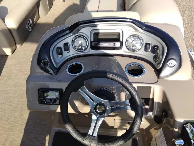 Slide: The Image of 2023 Sun Tracker SportFish 22 DLX boat dashboard with steering wheel and controls. - 7