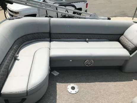 Slide: The Image of 2023 Ranger Reata 220C boat with spacious gray seating area. - 10