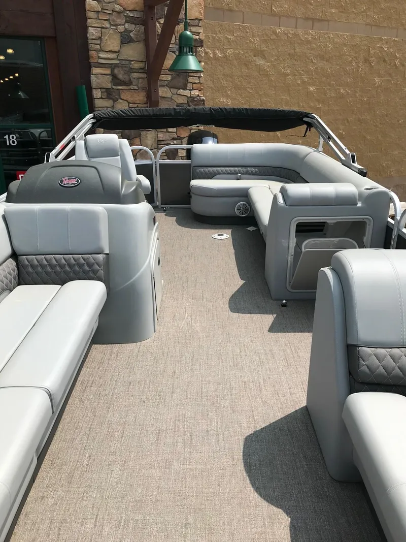 Slide: The Image of 2023 Ranger Reata 220C pontoon boat with spacious seating and modern interior design. - 8