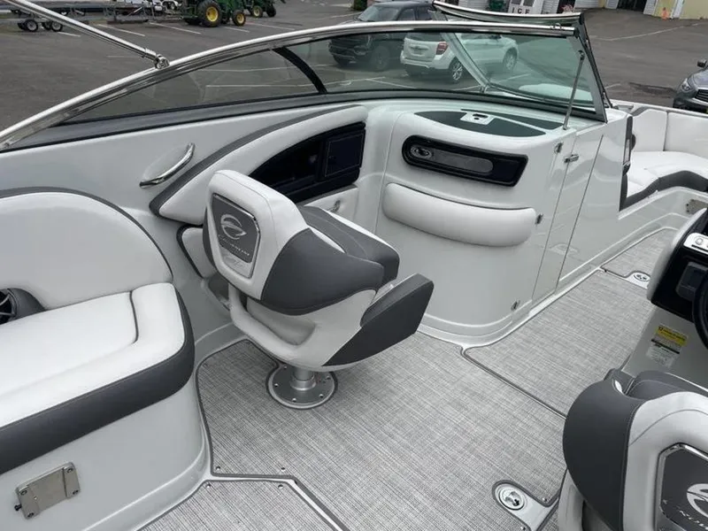 Slide: The Image of 2024 Crownline SS 260 boat interior with white and gray seating and modern dashboard. - 4
