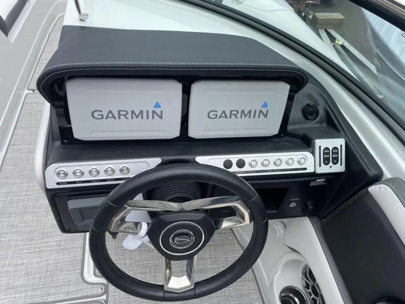 Slide: The Image of 2024 Crownline SS 260 boat dashboard with Garmin navigation screens and steering wheel. - 5