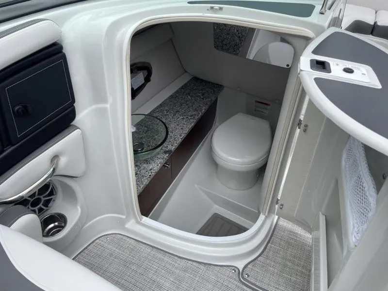 Slide: The Image of 2024 Crownline SS 260 boat interior bathroom with modern amenities. - 6