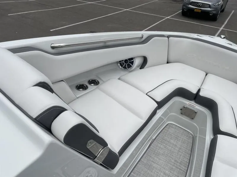 Slide: The Image of 2024 Crownline SS 260 boat interior with white and black seating, cup holders, and speaker. - 8