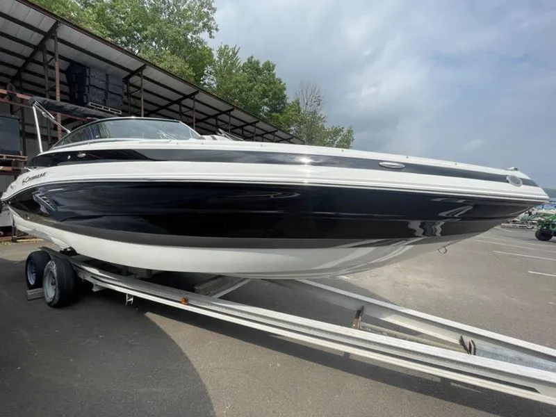 Slide: The Image of 2024 Crownline SS 260 boat on trailer, black and white exterior. - 9
