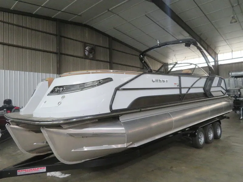 Slide: The Image of 2023 Crest Continental 270 NX SLS Twin pontoon boat in indoor storage. - 11