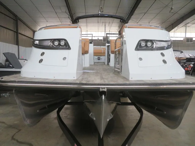 Slide: The Image of 2023 Crest Continental 270 NX SLS Twin pontoon boat in a warehouse. - 12