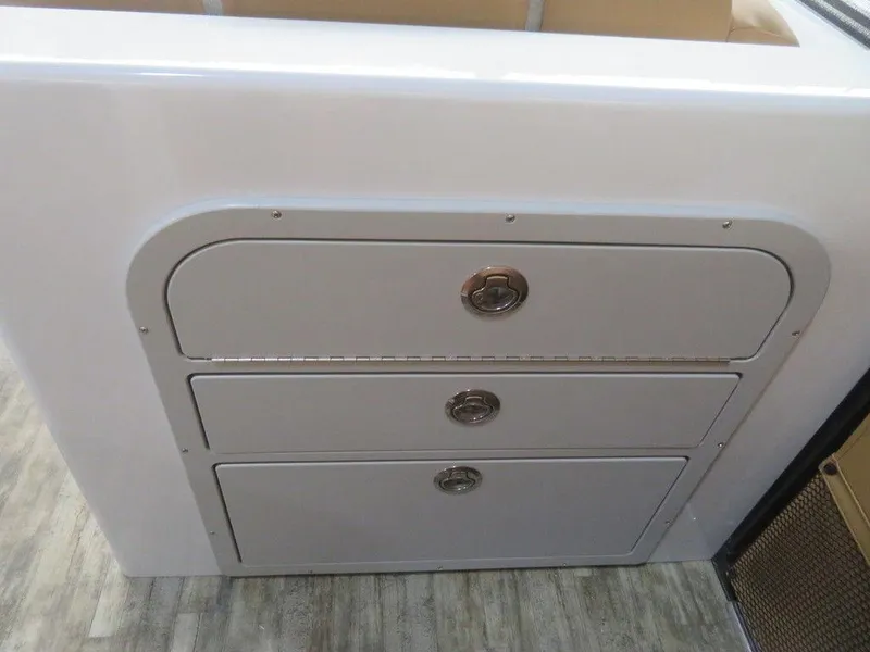 Slide: The Image of 2023 Crest Continental 270 NX SLS Twin storage compartments on boat interior - 13