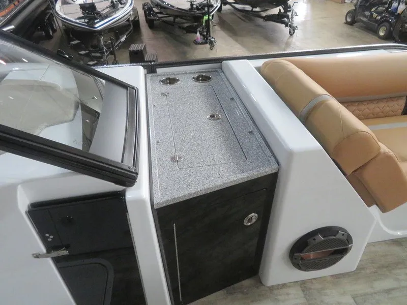 Slide: The Image of 2023 Crest Continental 270 NX SLS Twin boat interior with granite countertop and tan seating. - 17