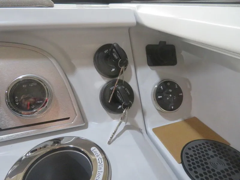 Slide: The Image of Control panel of 2023 Crest Continental 270 NX SLS Twin boat with ignition keys and gauges. - 23