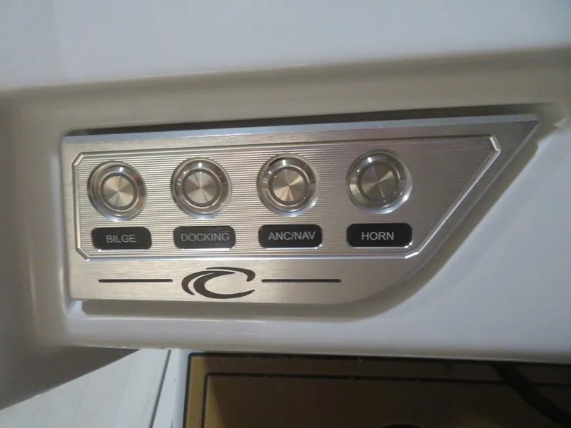 Slide: The Image of Control panel of 2023 Crest Continental 270 NX SLS Twin boat with bilge, docking, ANC/NAV, and horn buttons. - 32