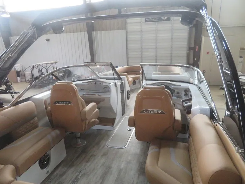Slide: The Image of 2023 Crest Continental 270 NX SLS Twin boat interior with tan seating and modern dashboard. - 35