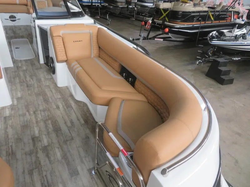 Slide: The Image of 2023 Crest Continental 270 NX SLS Twin boat interior with tan seating and wood flooring. - 5
