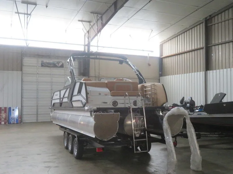 Slide: The Image of 2023 Crest Continental 270 NX SLS Twin pontoon boat in a warehouse. - 6