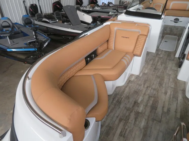Slide: The Image of 2023 Crest Continental 270 NX SLS Twin boat with luxurious tan seating and modern interior. - 7
