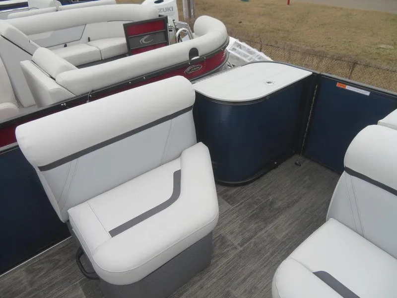 Slide: The Image of 2023 Crest Classic LX 220 L CPT DLX pontoon boat interior with white seating. - 2