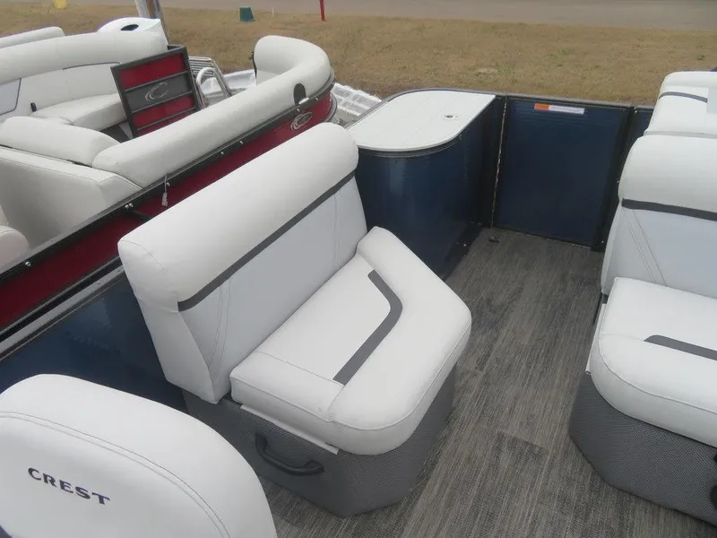 Slide: The Image of 2023 Crest Classic LX 220 L CPT DLX pontoon boat interior with white seating. - 5
