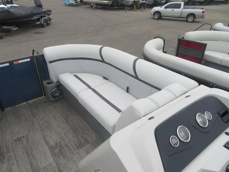 Slide: The Image of 2023 Crest Classic LX 220 L CPT DLX pontoon boat interior with white seating. - 9