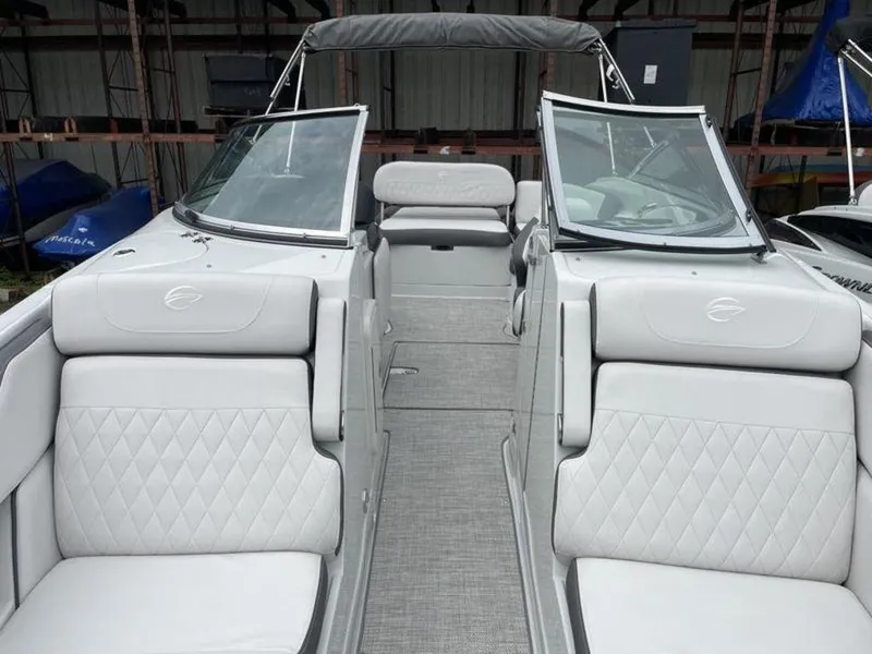 Slide: The Image of 2024 Crownline Eclipse E 255 boat interior with white leather seats and open bow. - 11