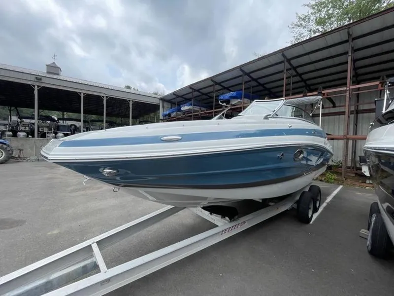 Slide: The Image of 2024 Crownline Eclipse E 255 boat on trailer, blue and white exterior. - 3