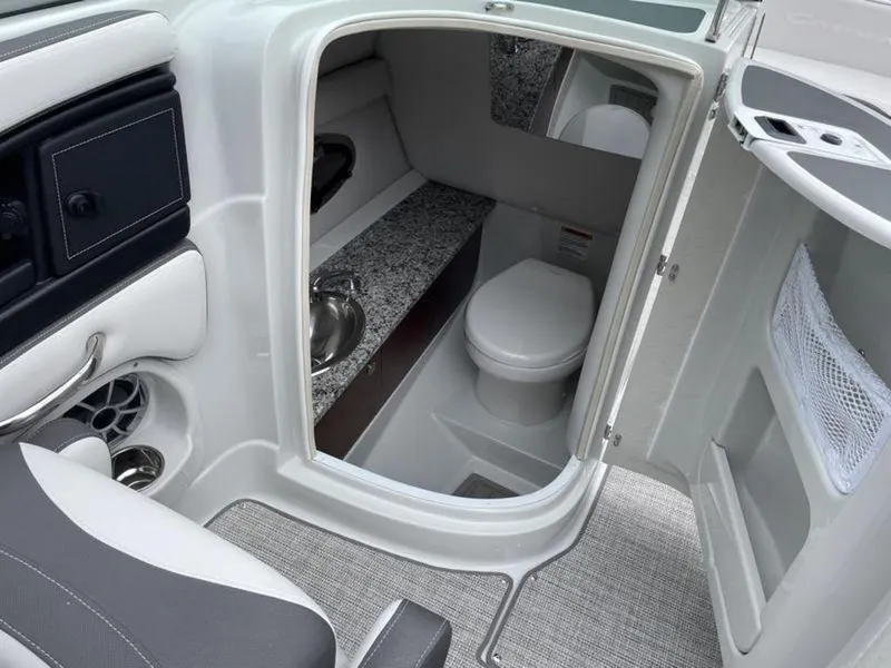 Slide: The Image of 2024 Crownline Eclipse E 255 boat interior with a compact bathroom. - 5
