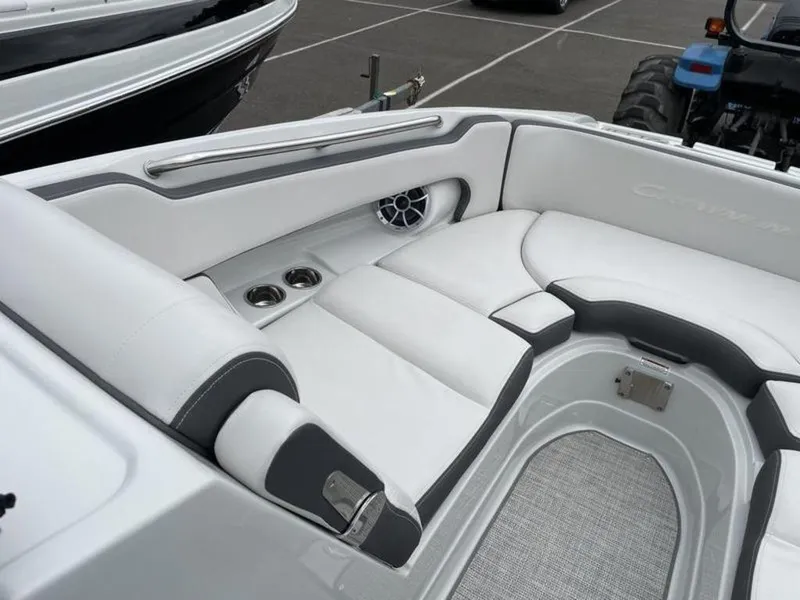 Slide: The Image of 2024 Crownline Eclipse E 255 boat interior with white seating and cup holders. - 7