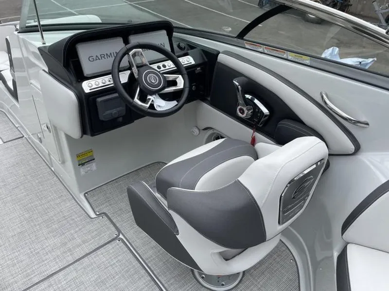 Slide: The Image of 2024 Crownline Eclipse E 255 boat cockpit with Garmin navigation system and captain's chair. - 9