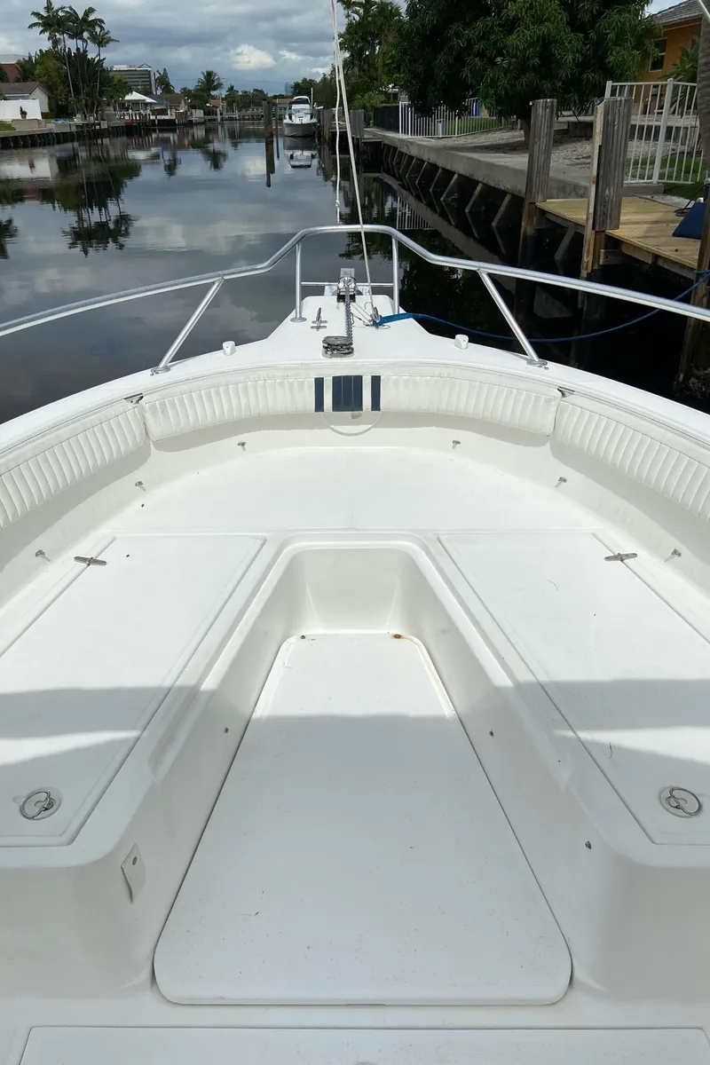 Slide: The Image of 2000 Stamas 290 Tarpon boat bow view, docked in a calm canal. - 11