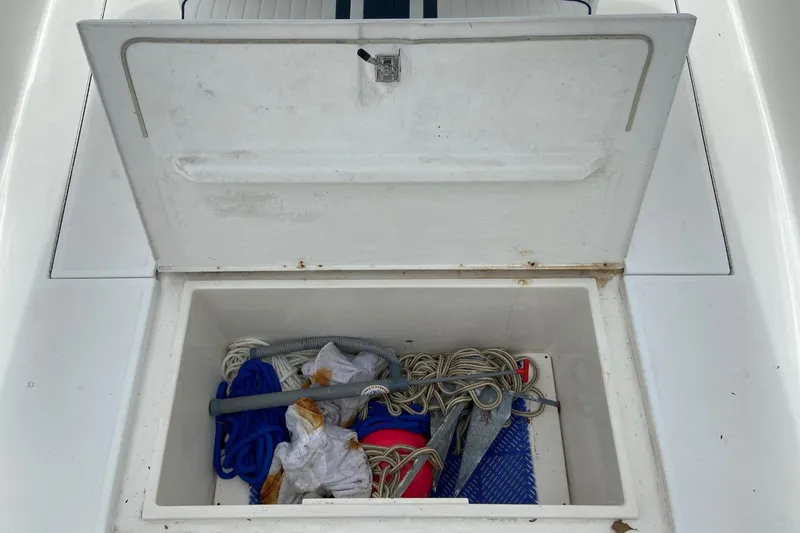 Slide: The Image of Storage compartment on a 2000 Stamas 290 Tarpon boat with ropes and equipment. - 13