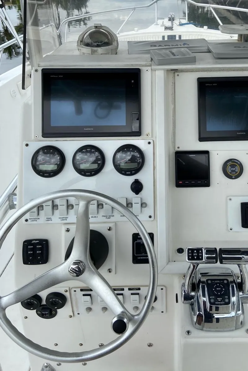 Slide: The Image of 2000 Stamas 290 Tarpon boat dashboard with steering wheel and navigation instruments. - 16