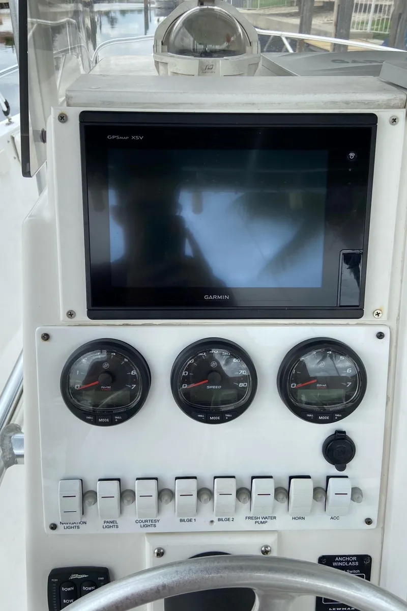 Slide: The Image of Control panel of a 2000 Stamas 290 Tarpon boat with gauges and switches. - 17