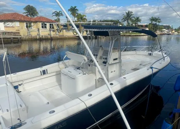 Slide: The Image of 2000 Stamas 290 Tarpon boat docked in a scenic canal. - 2
