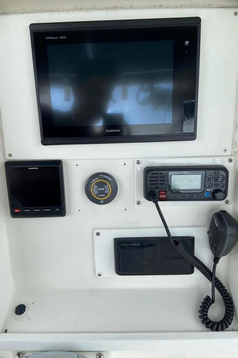Slide: The Image of Control panel of a 2000 Stamas 290 Tarpon boat with navigation and communication equipment. - 20