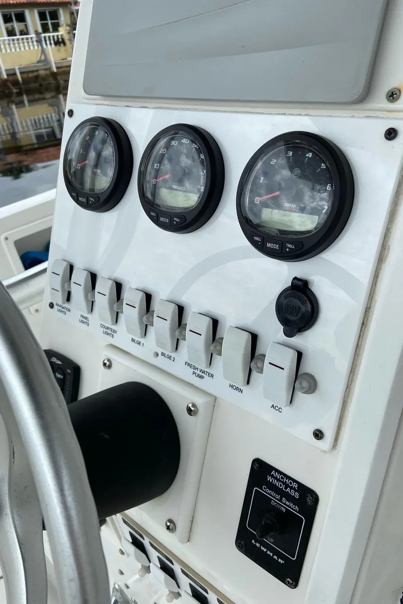 Slide: The Image of Control panel of a 2000 Stamas 290 Tarpon boat with gauges and switches. - 21