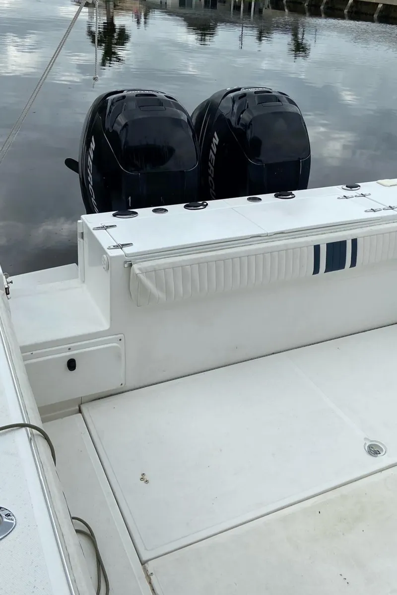 Slide: The Image of 2000 Stamas 290 Tarpon boat with twin outboard engines on calm water. - 24