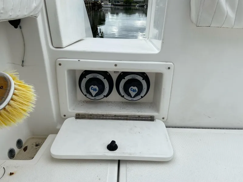 Slide: The Image of Storage compartment on a 2000 Stamas 290 Tarpon boat with two gauges. - 27