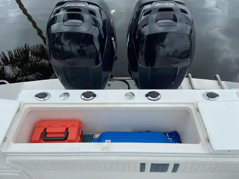 Slide: The Image of 2000 Stamas 290 Tarpon boat with twin outboard engines and storage compartment. - 28
