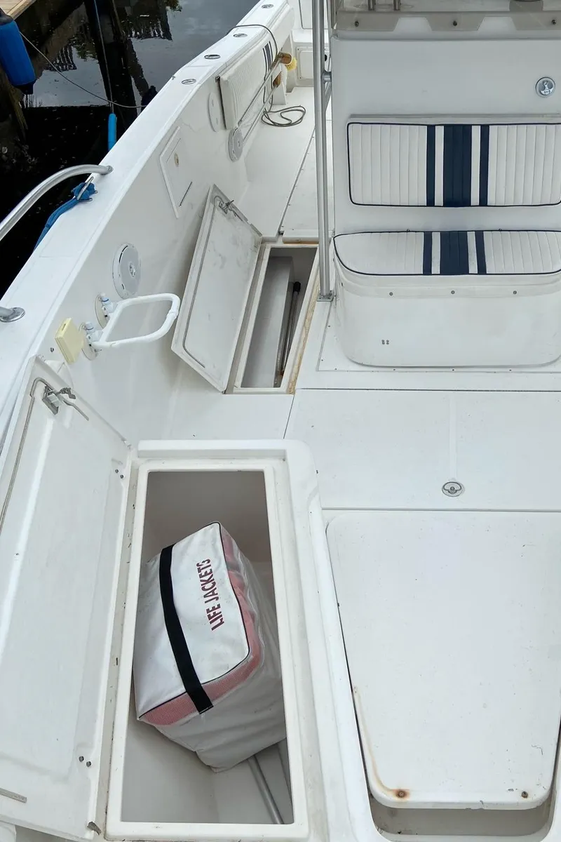 Slide: The Image of 2000 Stamas 290 Tarpon boat interior with storage compartments and seating. - 5